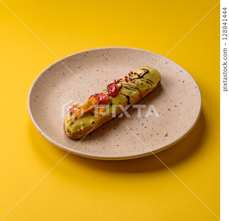 French food, dessert eclair with chocolate filling. Eclair as a background 128841444