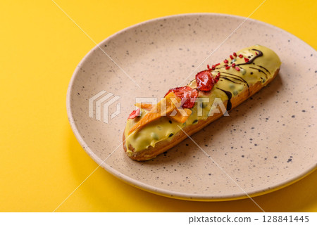 French food, dessert eclair with chocolate filling. Eclair as a background French food, dessert eclair with chocolate filling. Eclair as a background 128841445