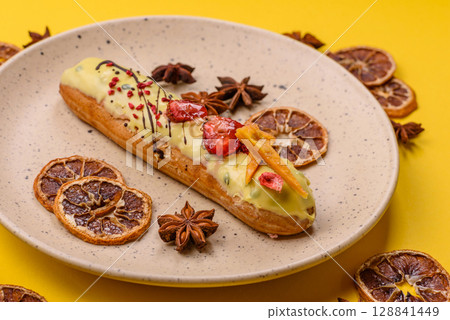 French food, dessert eclair with chocolate filling. Eclair as a background 128841449