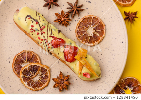 French food, dessert eclair with chocolate filling. Eclair as a background 128841450