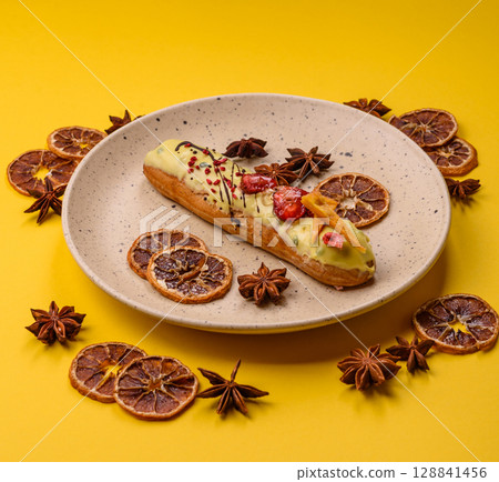 French food, dessert eclair with chocolate filling. Eclair as a background 128841456