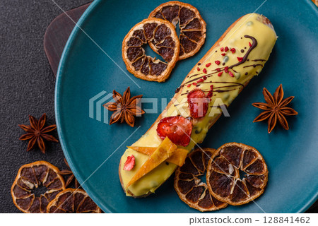 French food, dessert eclair with chocolate filling. Eclair as a background 128841462