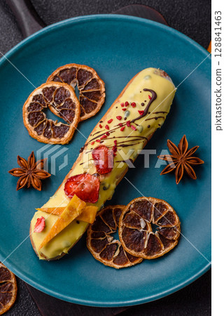 French food, dessert eclair with chocolate filling. Eclair as a background French food, dessert eclair with chocolate filling. Eclair as a background 128841463