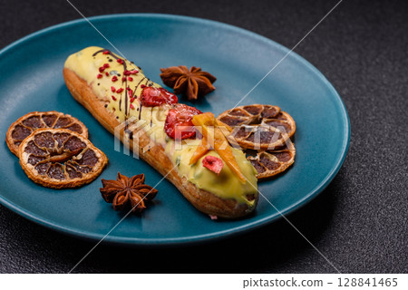 French food, dessert eclair with chocolate filling. Eclair as a background 128841465