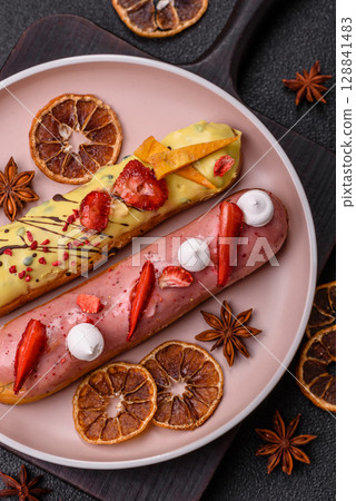 French food, dessert eclair with chocolate filling. Eclair as a background French food, dessert eclair with chocolate filling. Eclair as a background 128841483