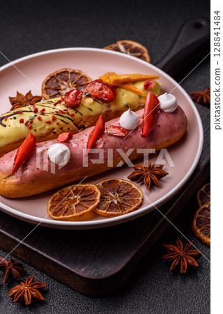 French food, dessert eclair with chocolate filling. Eclair as a background French food, dessert eclair with chocolate filling. Eclair as a background 128841484