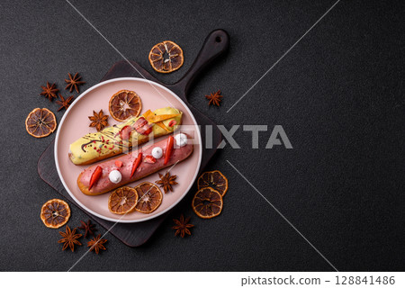French food, dessert eclair with chocolate filling. Eclair as a background French food, dessert eclair with chocolate filling. Eclair as a background 128841486