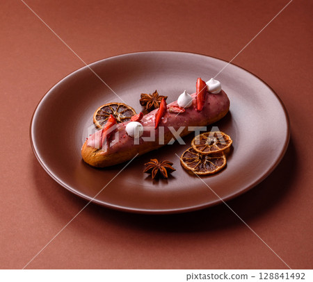 French food, dessert eclair with chocolate filling. Eclair as a background 128841492