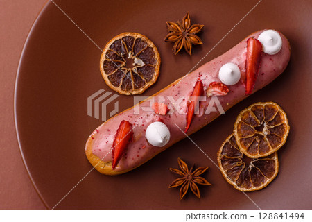 French food, dessert eclair with chocolate filling. Eclair as a background French food, dessert eclair with chocolate filling. Eclair as a background 128841494