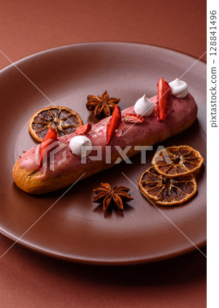 French food, dessert eclair with chocolate filling. Eclair as a background 128841496