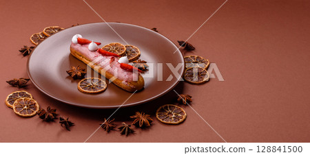 French food, dessert eclair with chocolate filling. Eclair as a background French food, dessert eclair with chocolate filling. Eclair as a background 128841500
