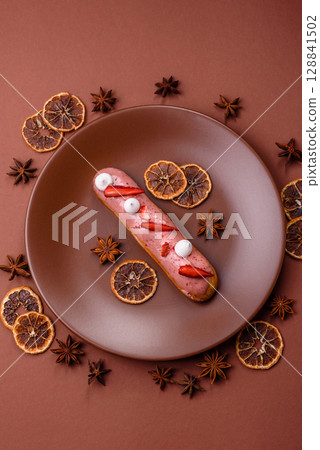 French food, dessert eclair with chocolate filling. Eclair as a background 128841502