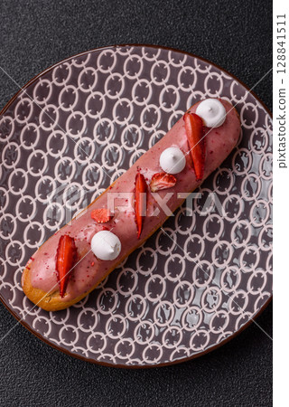French food, dessert eclair with chocolate filling. Eclair as a background 128841511