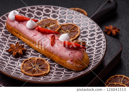 French food, dessert eclair with chocolate filling. Eclair as a background 128841513