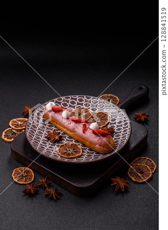 French food, dessert eclair with chocolate filling. Eclair as a background 128841519