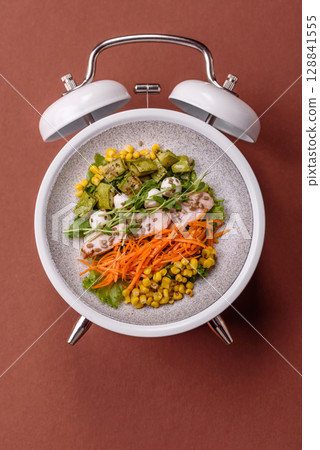 Salad with chicken, tomatoes and eggs with seeds and grains. Concept time to eat dinner Salad with chicken, tomatoes and eggs with seeds and grains. Concept time to eat dinner 128841555