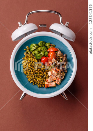 Vegetarian salad with quinoa, vegetables and meat. Conceptual background time to eat vegetarian food Vegetarian salad with quinoa, vegetables and meat. Conceptual background time to eat vegetarian food 128841556