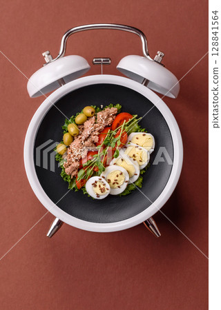Salad with chicken, tomatoes and eggs with seeds and grains. Concept time to eat dinner Salad with chicken, tomatoes and eggs with seeds and grains. Concept time to eat dinner 128841564