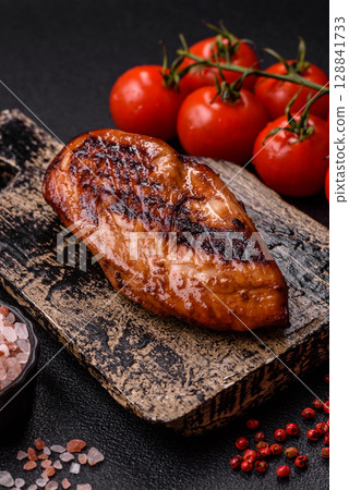 Chicken breast, grilled fillet, meat meal on a plate. Grilled poultry for dinner Chicken breast, grilled fillet, meat meal on a plate. Grilled poultry for dinner 128841733