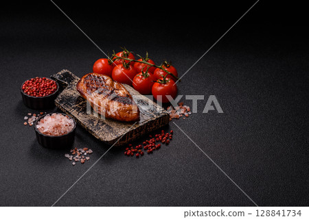 Chicken breast, grilled fillet, meat meal on a plate. Grilled poultry for dinner Chicken breast, grilled fillet, meat meal on a plate. Grilled poultry for dinner 128841734