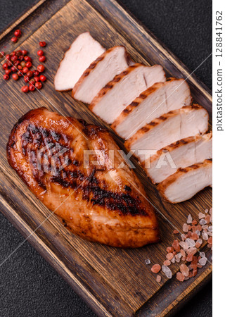 Chicken breast, grilled fillet, meat meal on a plate. Grilled poultry for dinner Chicken breast, grilled fillet, meat meal on a plate. Grilled poultry for dinner 128841762