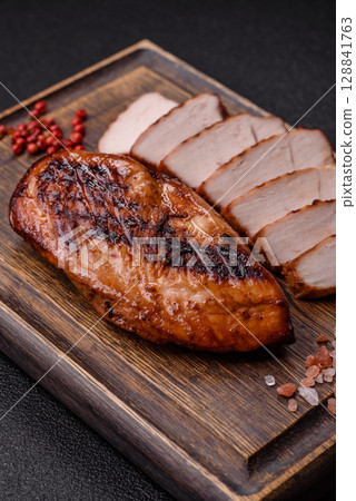 Chicken breast, grilled fillet, meat meal on a plate. Grilled poultry for dinner Chicken breast, grilled fillet, meat meal on a plate. Grilled poultry for dinner 128841763