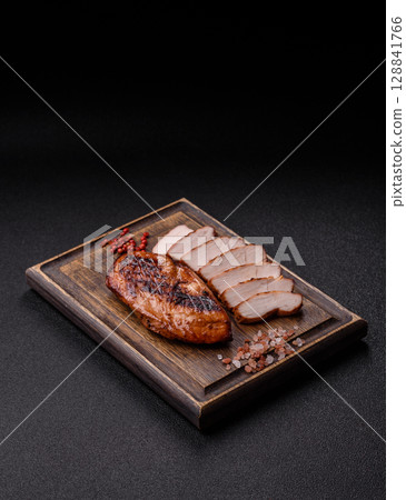 Chicken breast, grilled fillet, meat meal on a plate. Grilled poultry for dinner Chicken breast, grilled fillet, meat meal on a plate. Grilled poultry for dinner 128841766