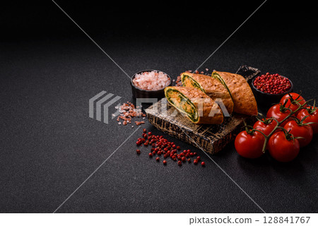 Roll of omelette, spinach, cheese and minced meat 128841767