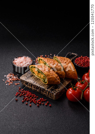 Roll of omelette, spinach, cheese and minced meat Roll of omelette, spinach, cheese and minced meat 128841770
