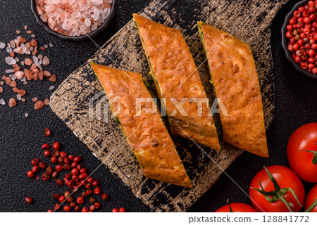 Roll of omelette, spinach, cheese and minced meat 128841772