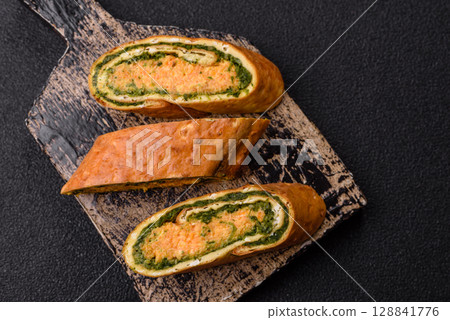 Roll of omelette, spinach, cheese and minced meat Roll of omelette, spinach, cheese and minced meat 128841776