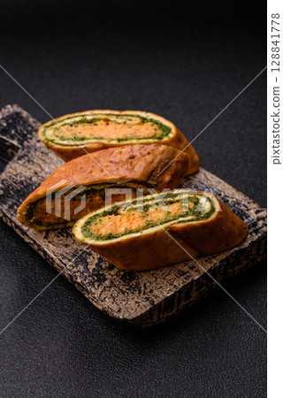 Roll of omelette, spinach, cheese and minced meat Roll of omelette, spinach, cheese and minced meat 128841778