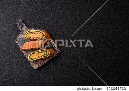 Roll of omelette, spinach, cheese and minced meat Roll of omelette, spinach, cheese and minced meat 128841780