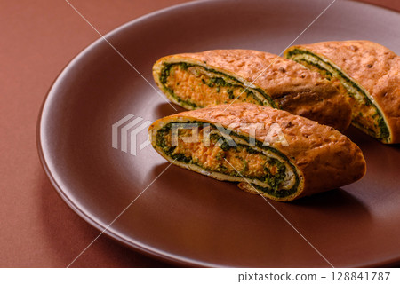 Roll of omelette, spinach, cheese and minced meat Roll of omelette, spinach, cheese and minced meat 128841787