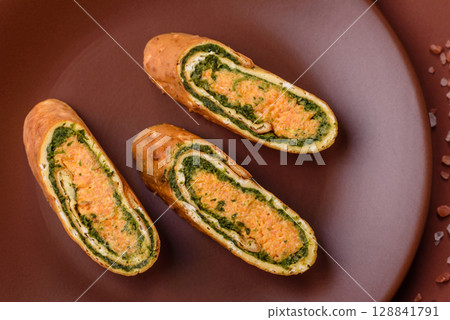 Roll of omelette, spinach, cheese and minced meat Roll of omelette, spinach, cheese and minced meat 128841791