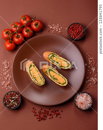 Roll of omelette, spinach, cheese and minced meat Roll of omelette, spinach, cheese and minced meat 128841795