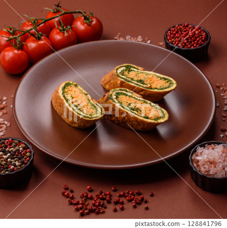 Roll of omelette, spinach, cheese and minced meat Roll of omelette, spinach, cheese and minced meat 128841796