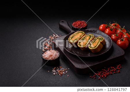 Roll of omelette, spinach, cheese and minced meat 128841797