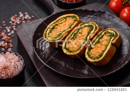 Roll of omelette, spinach, cheese and minced meat Roll of omelette, spinach, cheese and minced meat 128841801
