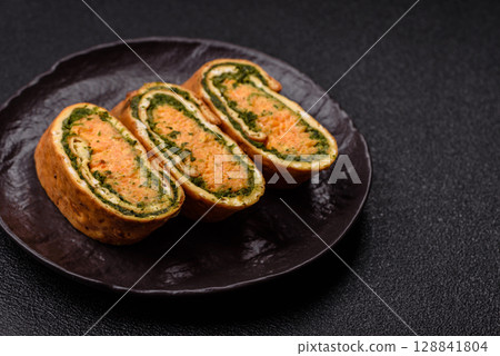 Roll of omelette, spinach, cheese and minced meat 128841804