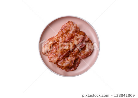 Cooked crispy bacon, slices of roast pork for an English breakfast. Fried bacon Cooked crispy bacon, slices of roast pork for an English breakfast. Fried bacon 128841809