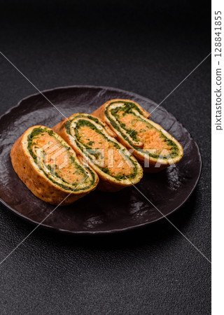Roll of omelette, spinach, cheese and minced meat 128841855