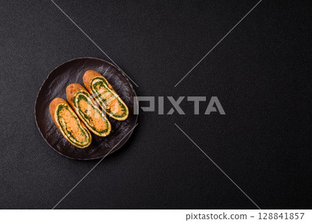 Roll of omelette, spinach, cheese and minced meat Roll of omelette, spinach, cheese and minced meat 128841857