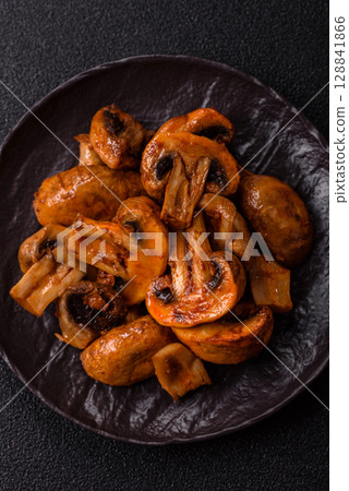Food, baked mushrooms champignon slices with sauce and spices Food, baked mushrooms champignon slices with sauce and spices 128841866