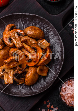 Food, baked mushrooms champignon slices with sauce and spices Food, baked mushrooms champignon slices with sauce and spices 128841870