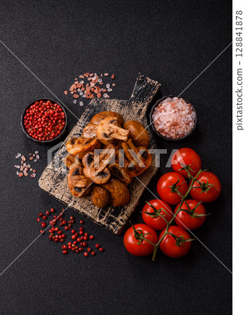 Food, baked mushrooms champignon slices with sauce and spices Food, baked mushrooms champignon slices with sauce and spices 128841878