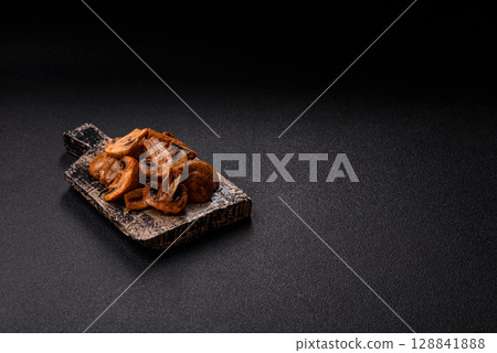 Food, baked mushrooms champignon slices with sauce and spices 128841888