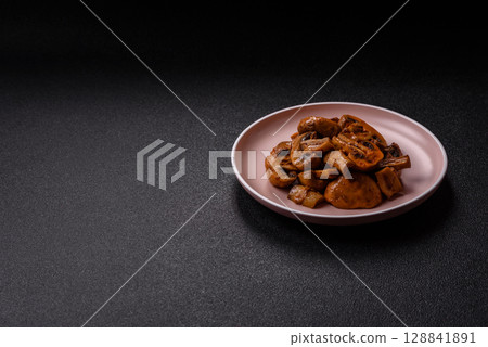 Food, baked mushrooms champignon slices with sauce and spices Food, baked mushrooms champignon slices with sauce and spices 128841891