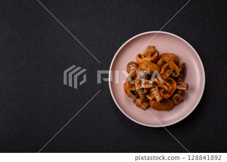 Food, baked mushrooms champignon slices with sauce and spices Food, baked mushrooms champignon slices with sauce and spices 128841892