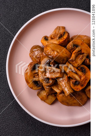 Food, baked mushrooms champignon slices with sauce and spices Food, baked mushrooms champignon slices with sauce and spices 128841896